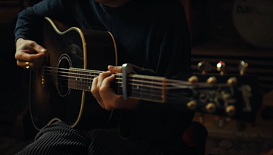 Leo Crawshaw-Bond of PARK RD playing an acoustic guitar