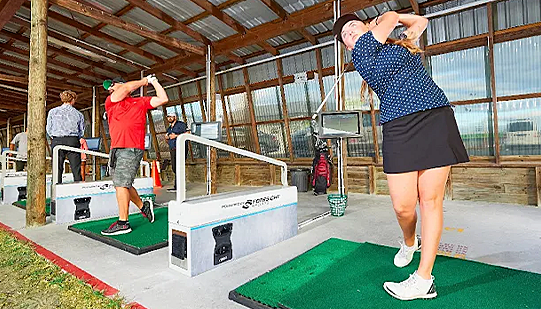 Golfers on the driving range at Golf 360