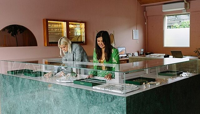 Servers standing behind a glass counter