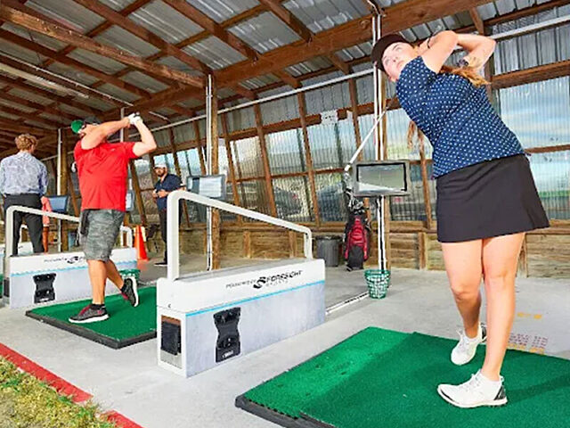 Golfers on the driving range at Golf 360